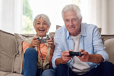 Buy stock photo Shot of a senior couple playing video games