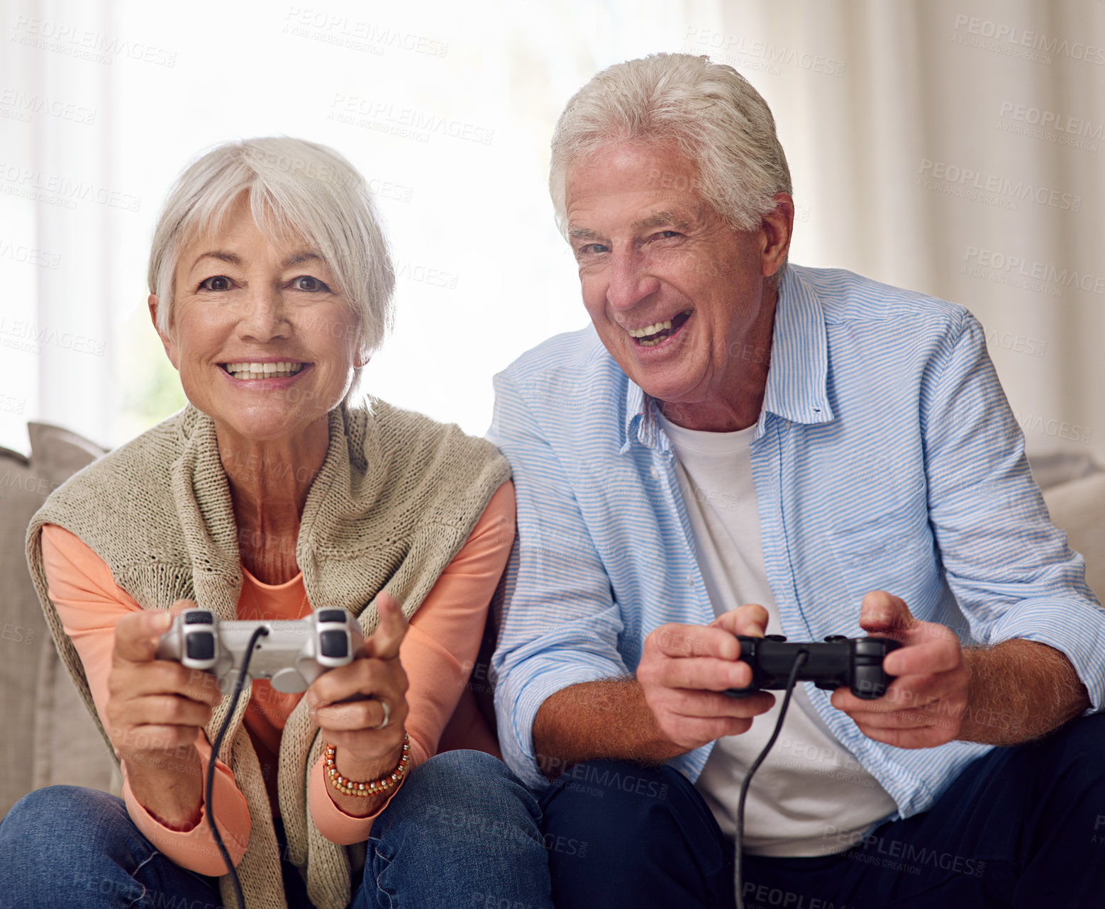 Buy stock photo Shot of a senior couple playing video games