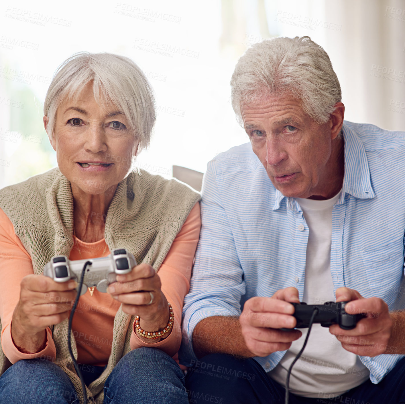 Buy stock photo Shot of a senior couple playing video games