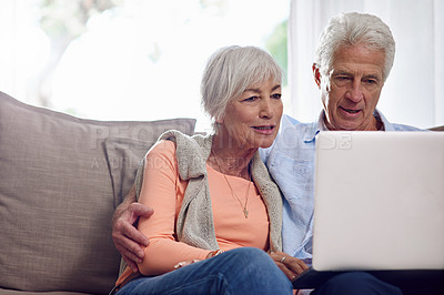 Buy stock photo Shot of a senior couple using a laptop at home