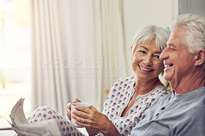 Buy stock photo Coffee, newspaper and a senior couple in bed, enjoying retirement in their home in the morning. Tea, reading or love with a happy mature man and woman in the bedroom together to relax while bonding