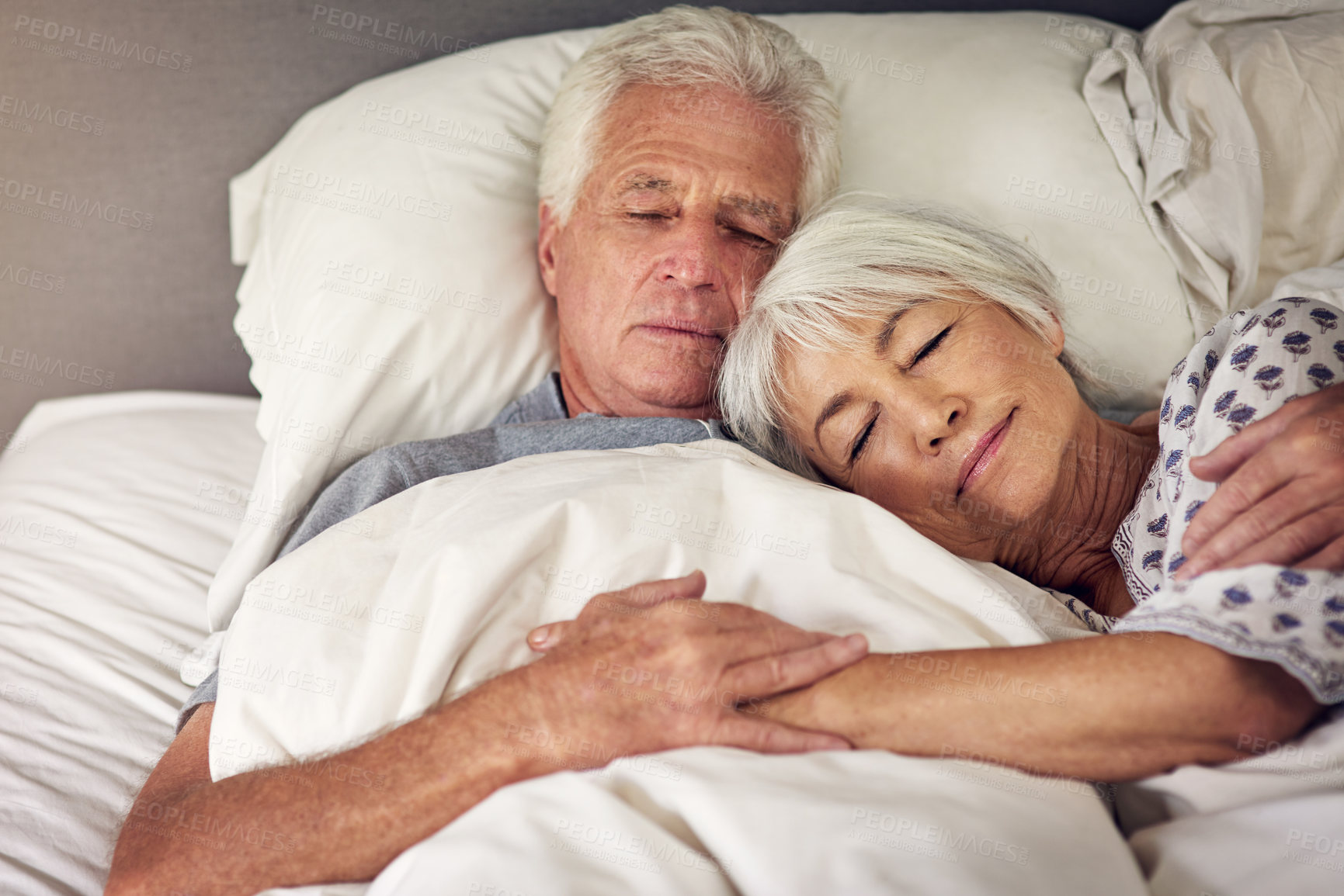 Buy stock photo Shot of a senior couple sleeping in bed