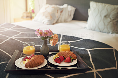 Buy stock photo Shot of a tray with breakfast on a bed