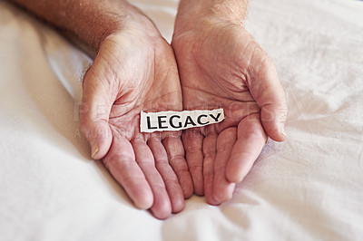 Buy stock photo Cropped shot of a person holding a piece of paper with the word legacy written on it