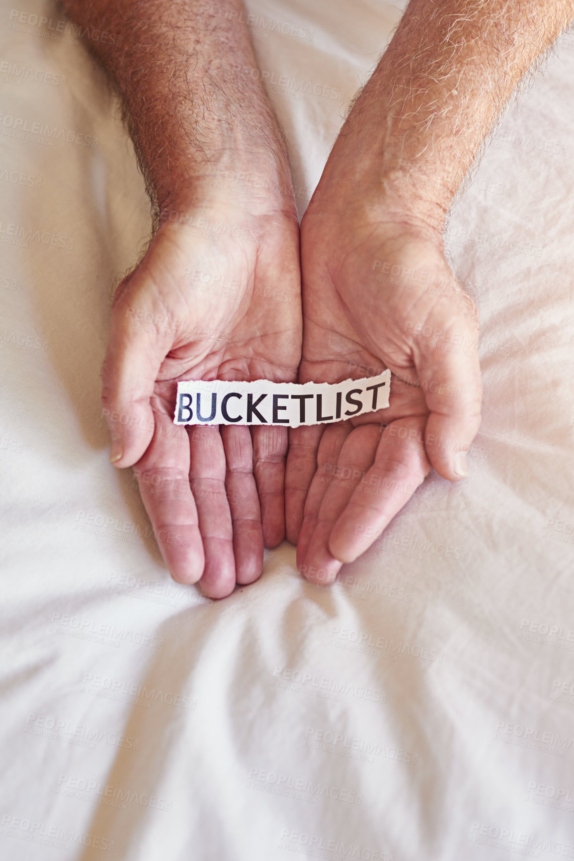 Buy stock photo Cropped shot of a person holding a piece of paper with the words bucket list written on it