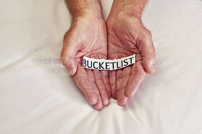 Buy stock photo Cropped shot of a person holding a piece of paper with the words bucket list written on it