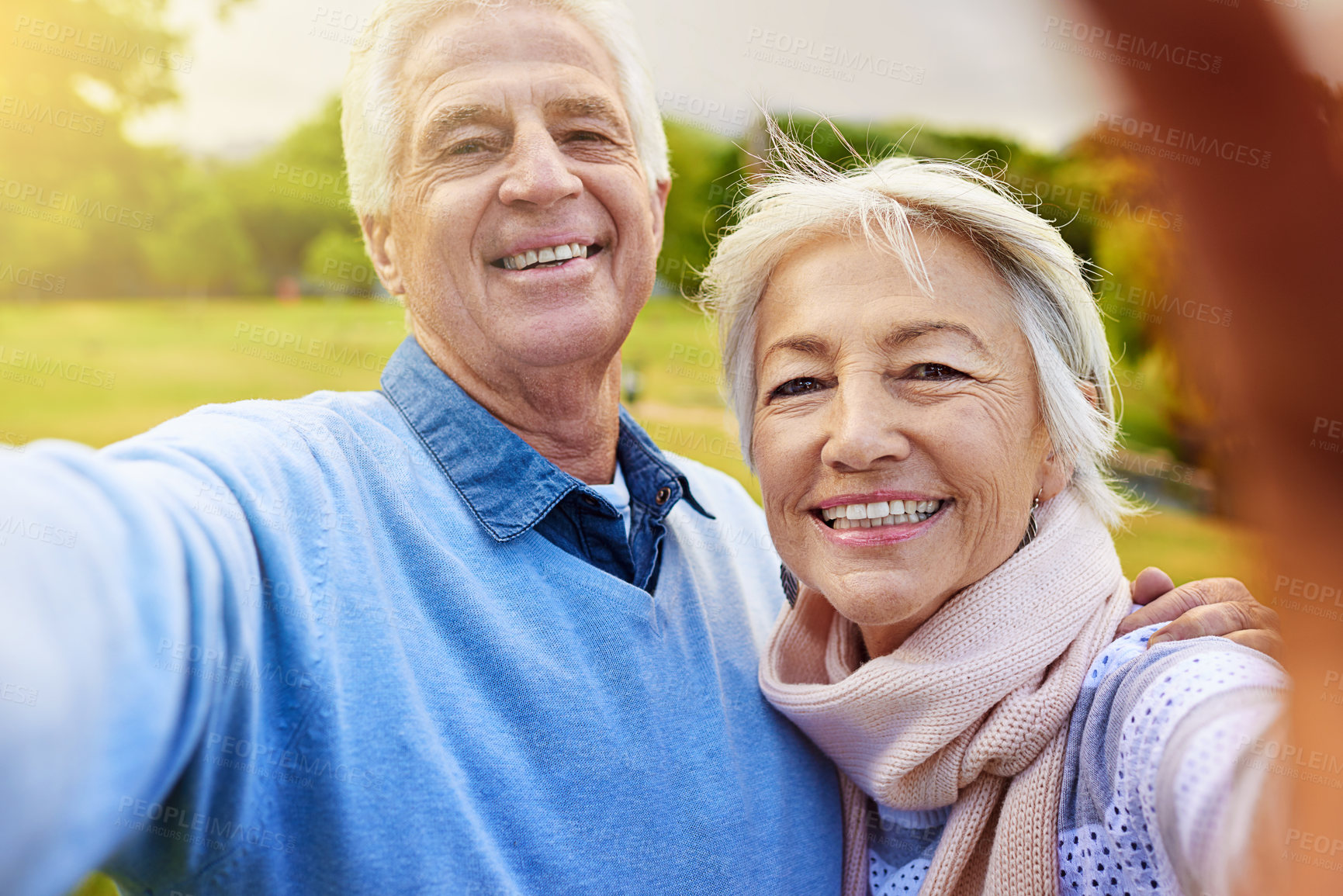 Buy stock photo Portrait of a senior couple taking a photo together in a park