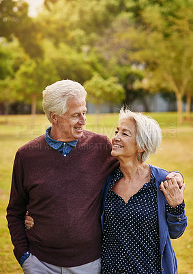 Buy stock photo Old couple, hug and holding hands while in the park, smile and happiness together with bonding in nature, love in retirement. Happy, man and woman travel, relationship with marriage and commitment