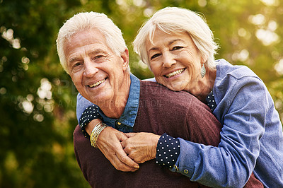 Buy stock photo Portrait of a happy senior couple enjoying a piggyback ride in the park