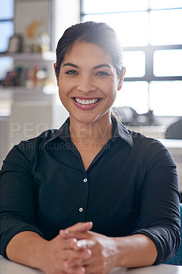 Buy stock photo Portrait of a young woman sitting in an office