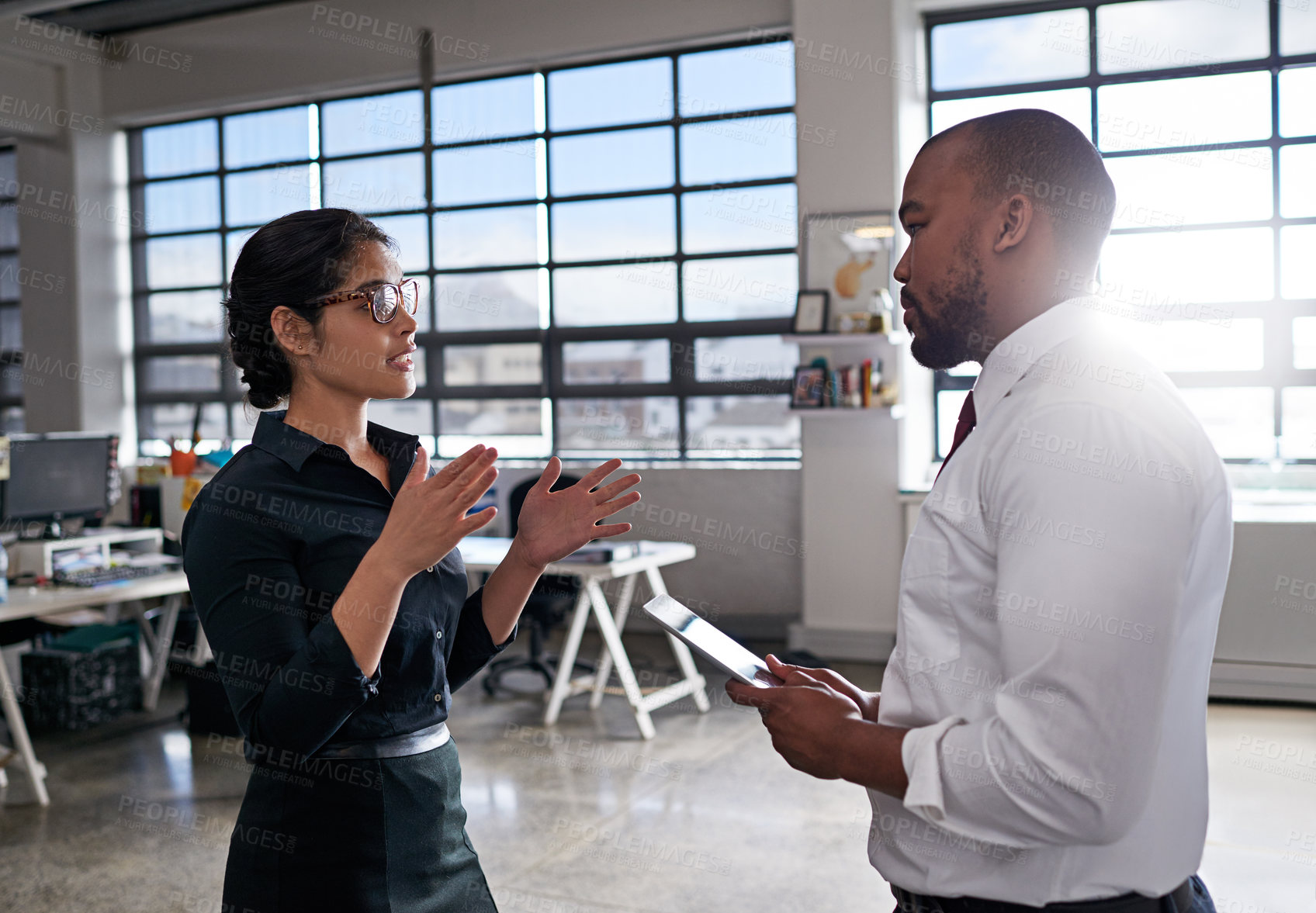 Buy stock photo Shot of colleagues having a discussion at the office