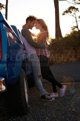 Buy stock photo Shot of an affectionate young couple on a roadtrip