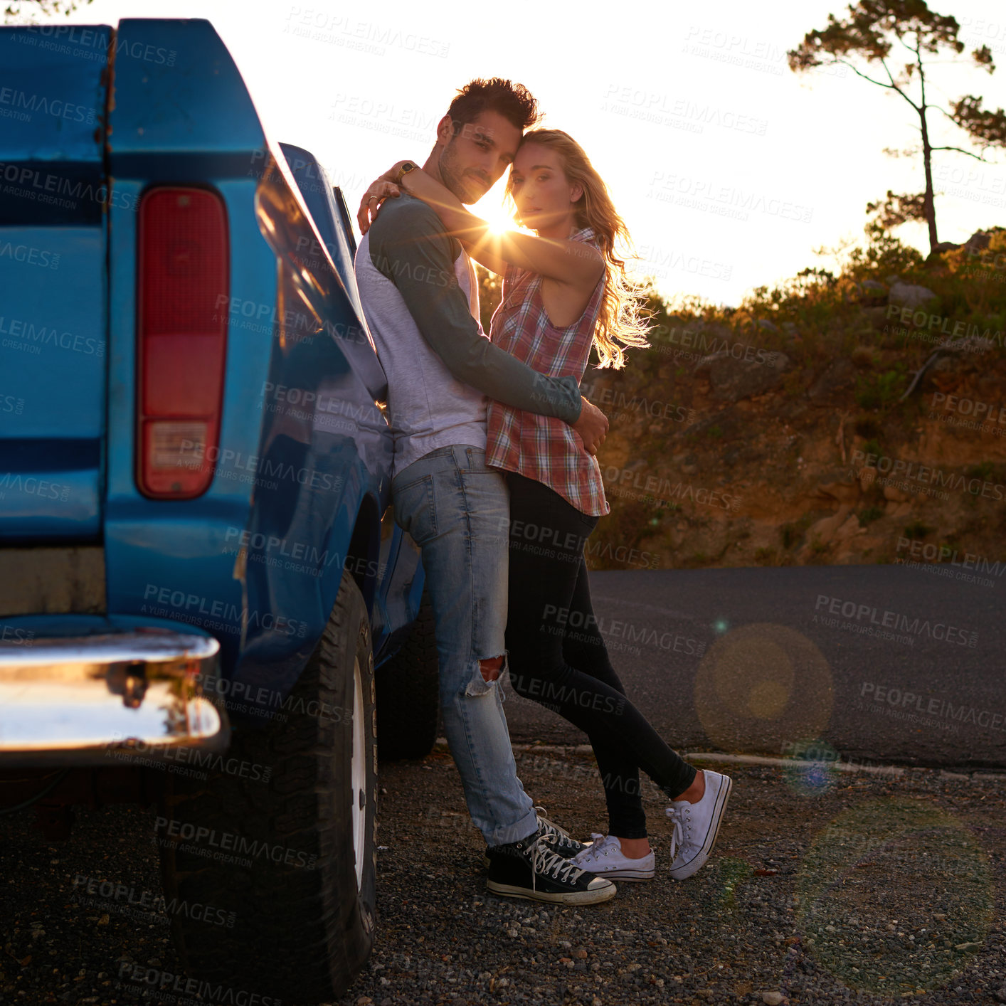 Buy stock photo Shot of an affectionate young couple on a roadtrip