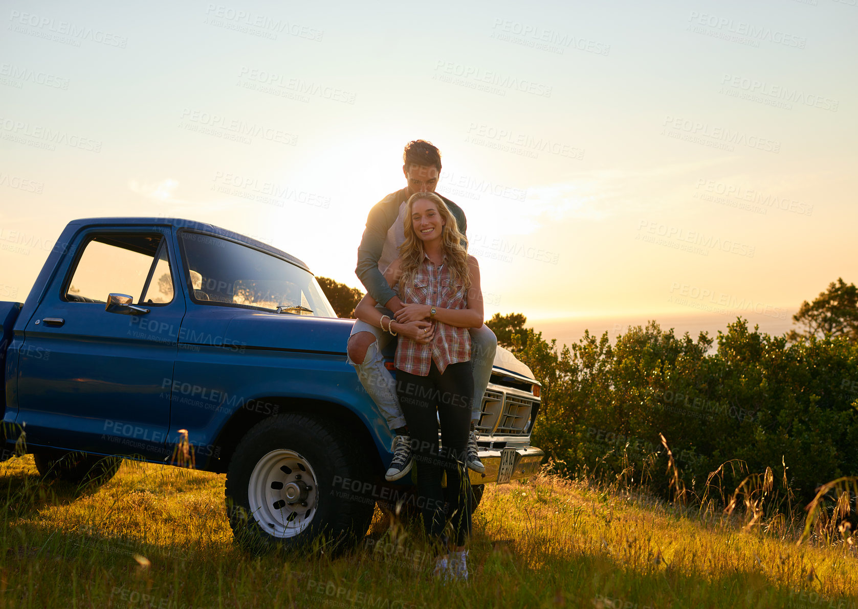Buy stock photo Couple, portrait and sunset by pickup truck in nature for road trip with love, romance and date on adventure. Man, woman and hug for freedom, journey and transportation for travel in countryside