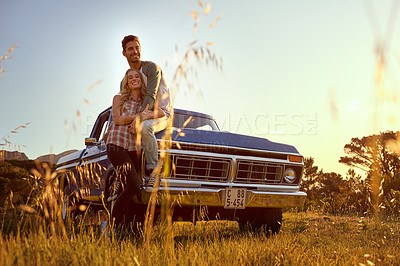 Buy stock photo Shot of an affectionate young couple on a roadtrip