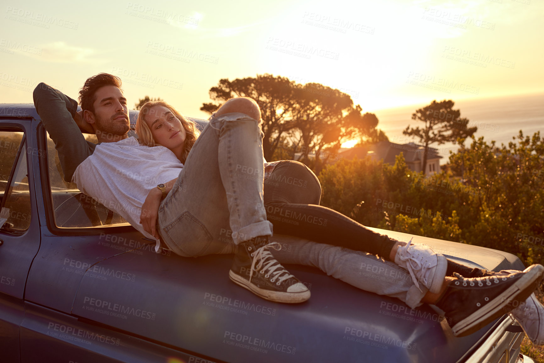 Buy stock photo Shot of an affectionate young couple on a roadtrip