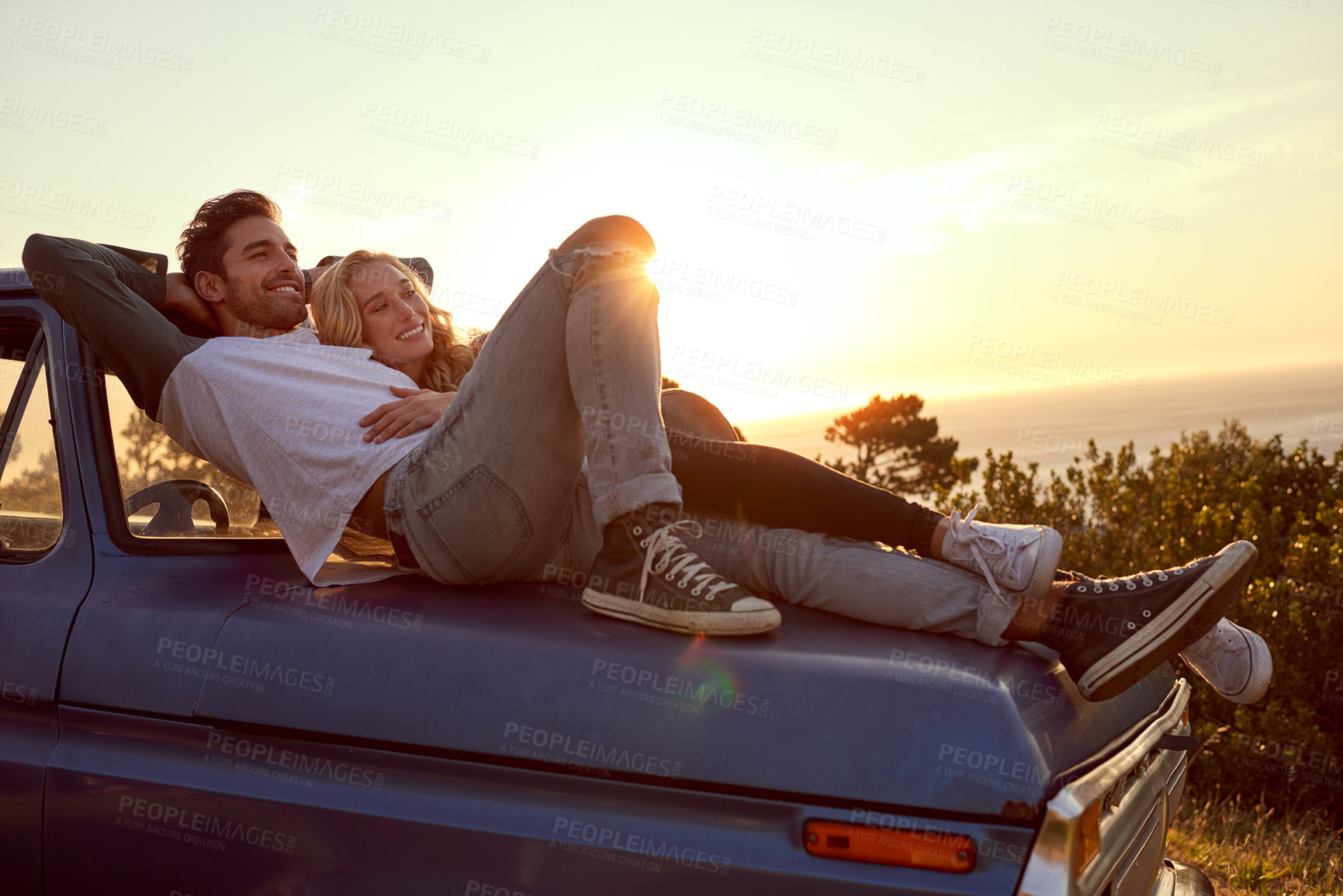 Buy stock photo Shot of an affectionate young couple on a roadtrip