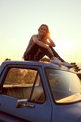 Buy stock photo Portrait of an attractive young woman sitting on the hood of her truck on a roadtrip