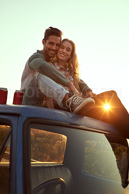 Buy stock photo Happy couple, portrait and relax with sunset on car for road trip, holiday or vacation together in nature. Man, woman or lovers with smile or hug on vehicle for travel adventure, journey or embrace