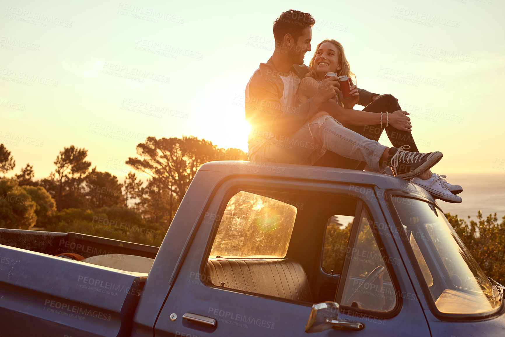 Buy stock photo Shot of an affectionate young couple on a roadtrip