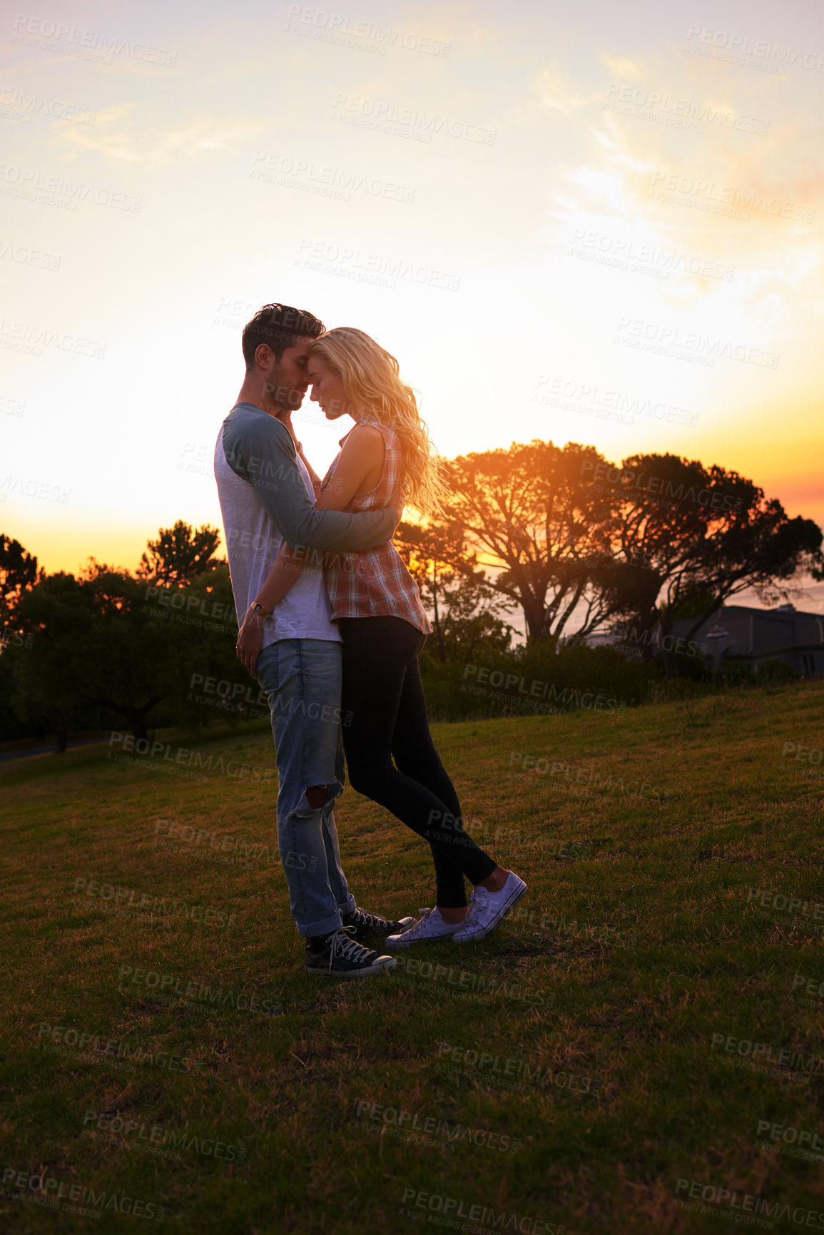 Buy stock photo Shot of an affectionate young outdoors