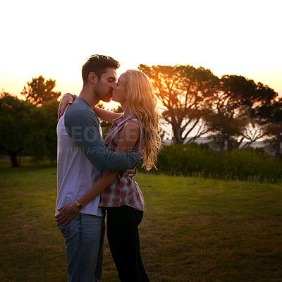 Buy stock photo Couple kiss, nature and trees in sunset with love, romance and date on adventure, travel or honeymoon. Man, woman and kissing with hug, care and outdoor for safari, freedom or holiday in countryside