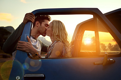 Buy stock photo Shot of an affectionate young couple on a roadtrip