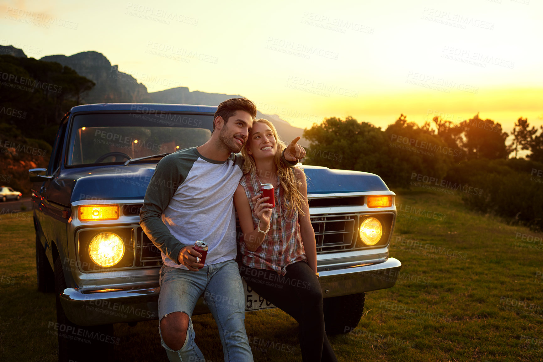 Buy stock photo Happy couple, pointing and car with sunset for road trip, holiday vacation or romantic date in nature. Man, woman or lovers with smile for adventure, travel or sightseeing on vehicle or grass field