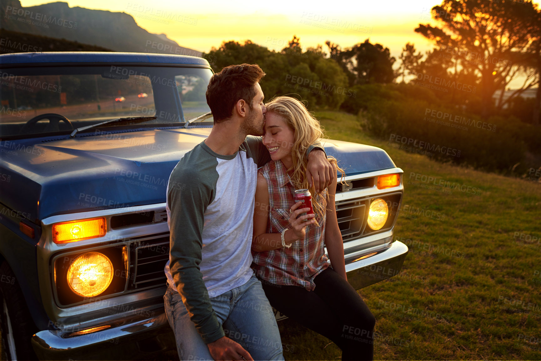 Buy stock photo Shot of an affectionate young couple on a roadtrip