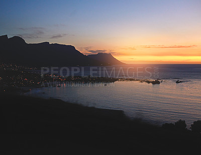 Buy stock photo Shot of a scenic sunset over the sea and mountain