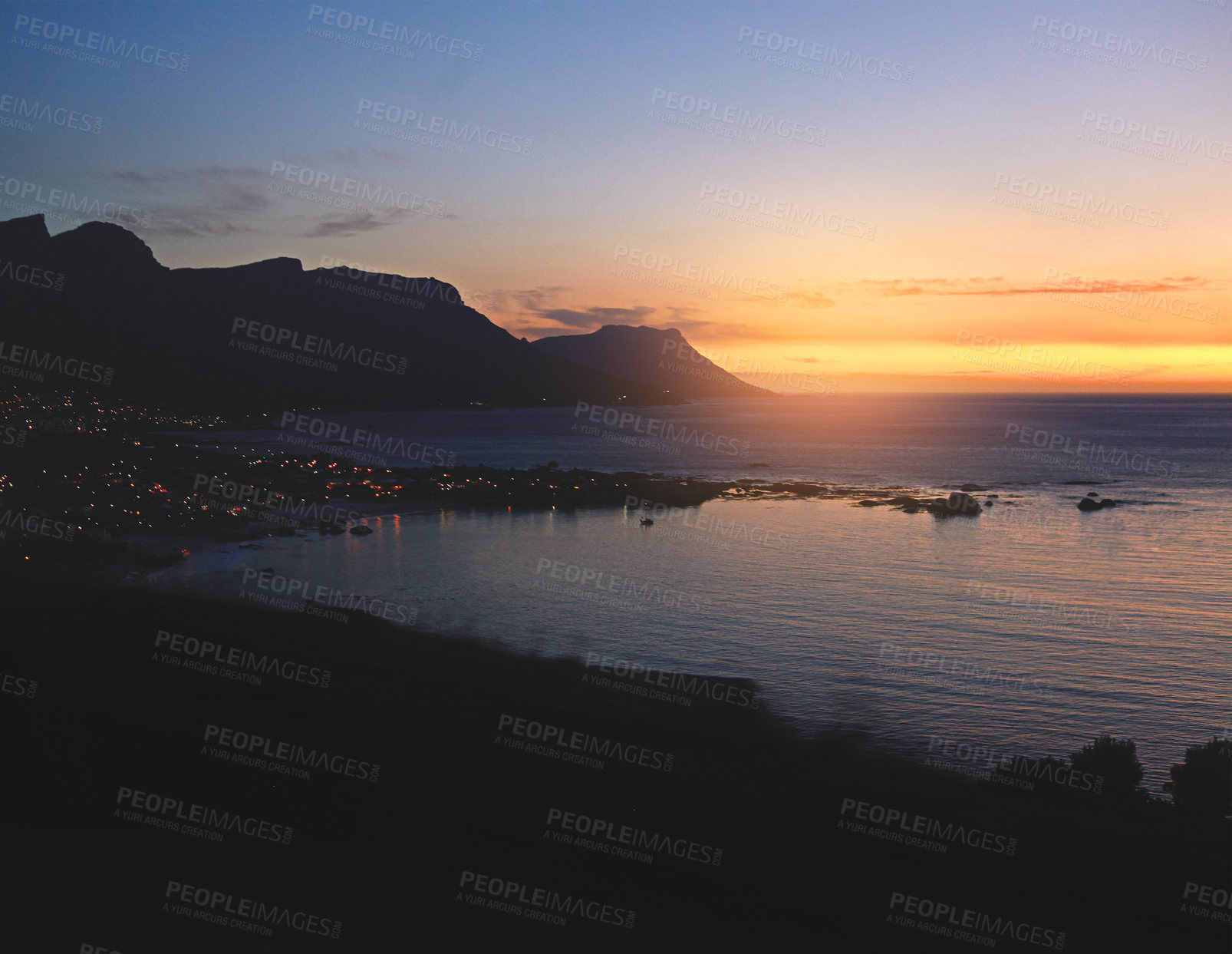 Buy stock photo Shot of a scenic sunset over the sea and mountain