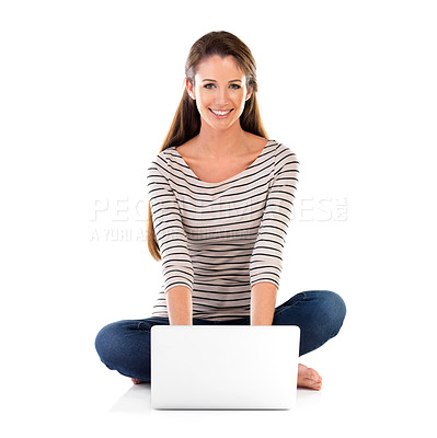 Buy stock photo Studio portrait of a young woman using a laptop against a white background