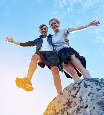 Buy stock photo Full length portrait of a young couple posing on a mountain top