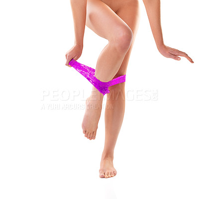 Buy stock photo Studio shot of a young woman taking off her panties against a white background