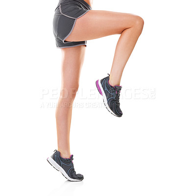 Buy stock photo Studio shot of a young woman in shorts and running shoes isolated on white
