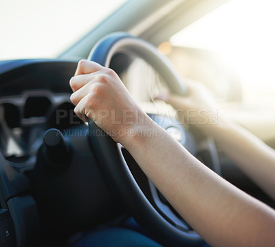 Buy stock photo Closeup shot of a woman holding onto a steering wheel while driving