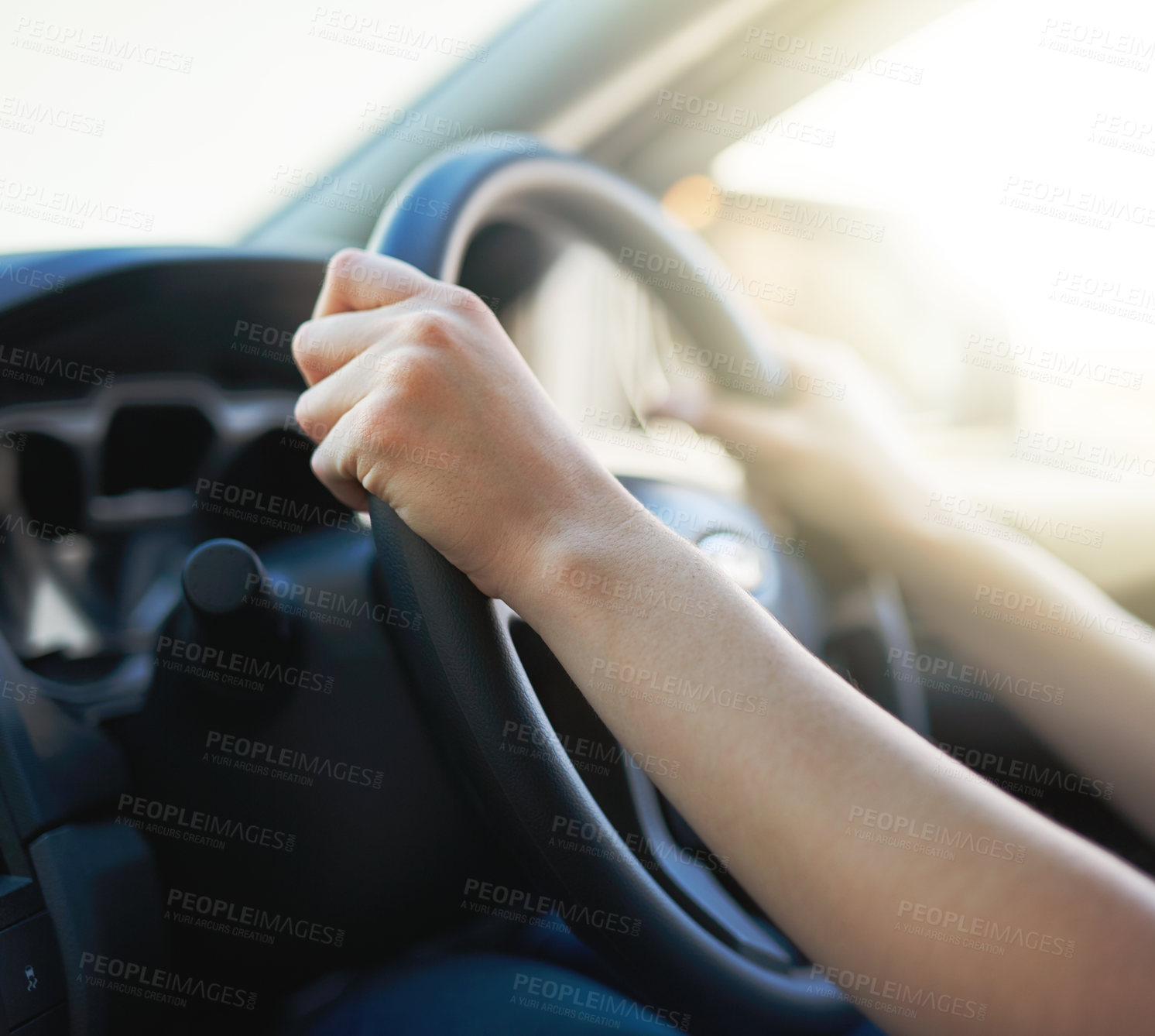 Buy stock photo Closeup shot of a woman holding onto a steering wheel while driving