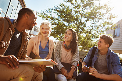 Buy stock photo Shot of a group of students studying outside on campus