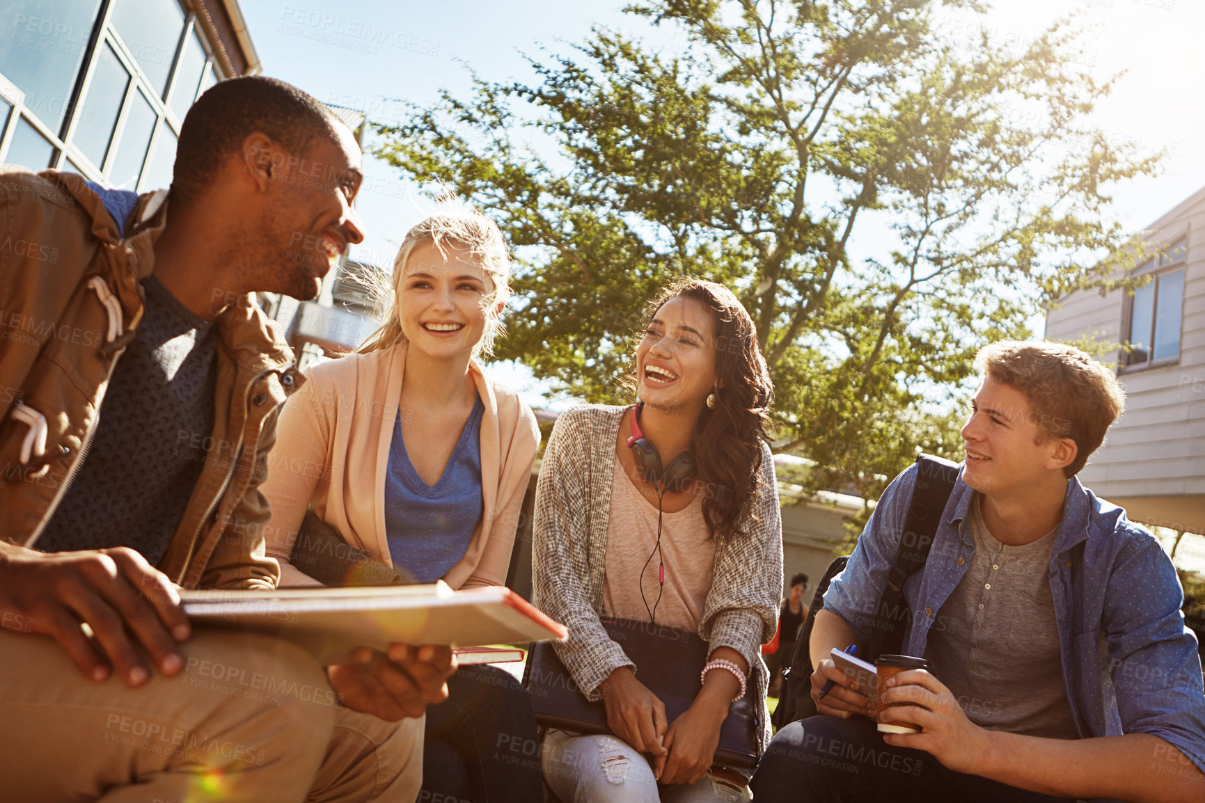 Buy stock photo Shot of a group of students studying outside on campus