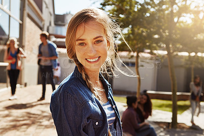 Buy stock photo Portrait of a student on campus with other students blurred in the background