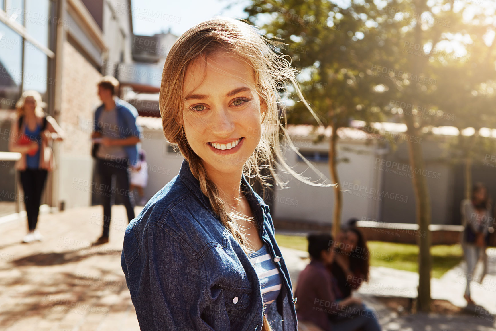 Buy stock photo Portrait of a student on campus with other students blurred in the background