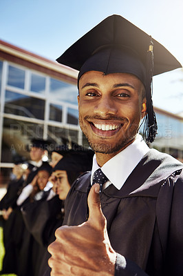 Buy stock photo Portrait of a smiling university student giving the thumbs up on graduation day