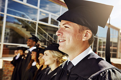 Buy stock photo Shot of students standing outside on graduation day from university