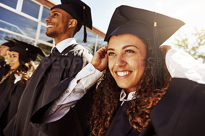 Buy stock photo Shot of a group of smiling university students outside on graduation day