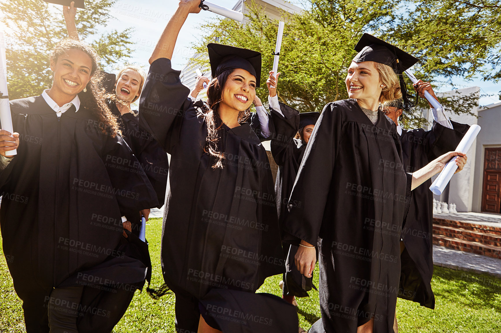 Buy stock photo Students, women and graduation celebration with certificate for education success or learning goals on campus. Group, friends and excited with diploma at ceremony for college achievement or milestone