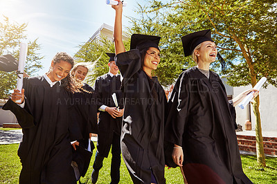 Buy stock photo Shot of a group of smiling university students cheering outside on graduation day