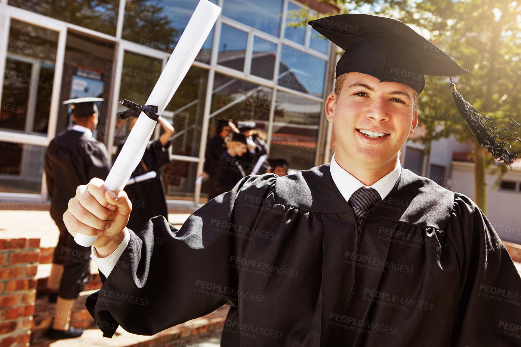 Buy stock photo Portrait, happy man and graduation of student with diploma at university for education achievement. Face, smile and college graduate with certificate outdoor for milestone, success and celebration