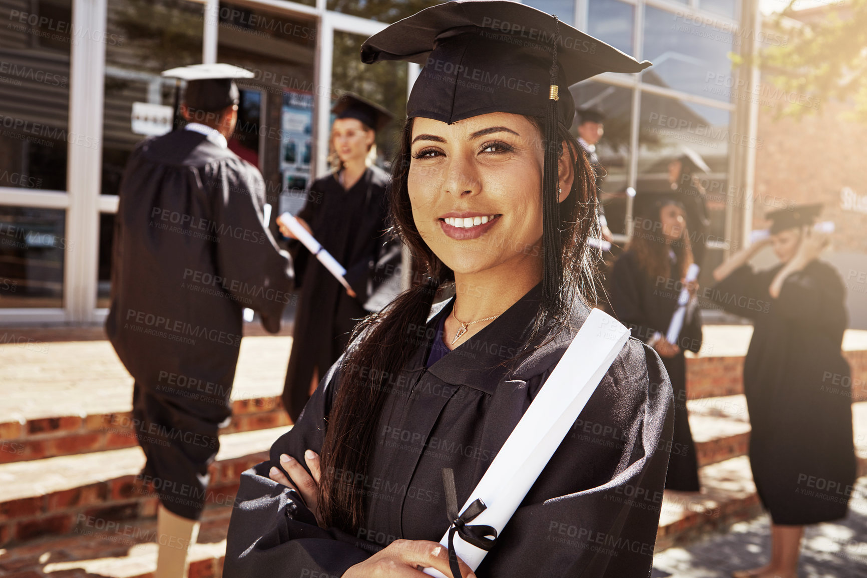 Buy stock photo Portrait, graduation and happy woman with diploma, arms crossed and student with pride for education achievement. Face, smile and confident college graduate with certificate outdoor for future goal