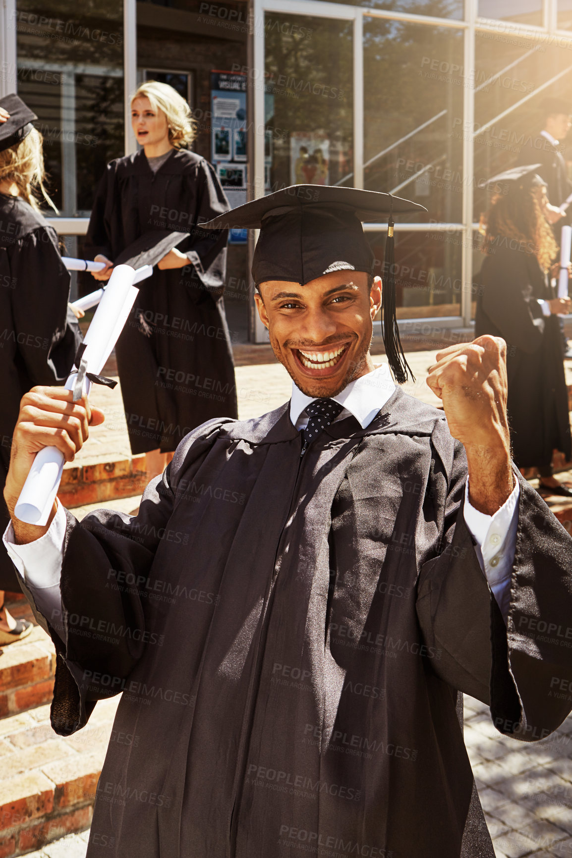 Buy stock photo Graduation, portrait and excited with man in college for success, education and scholarship. University student, future and pride with person in outdoor for campus ceremony, event and achievement