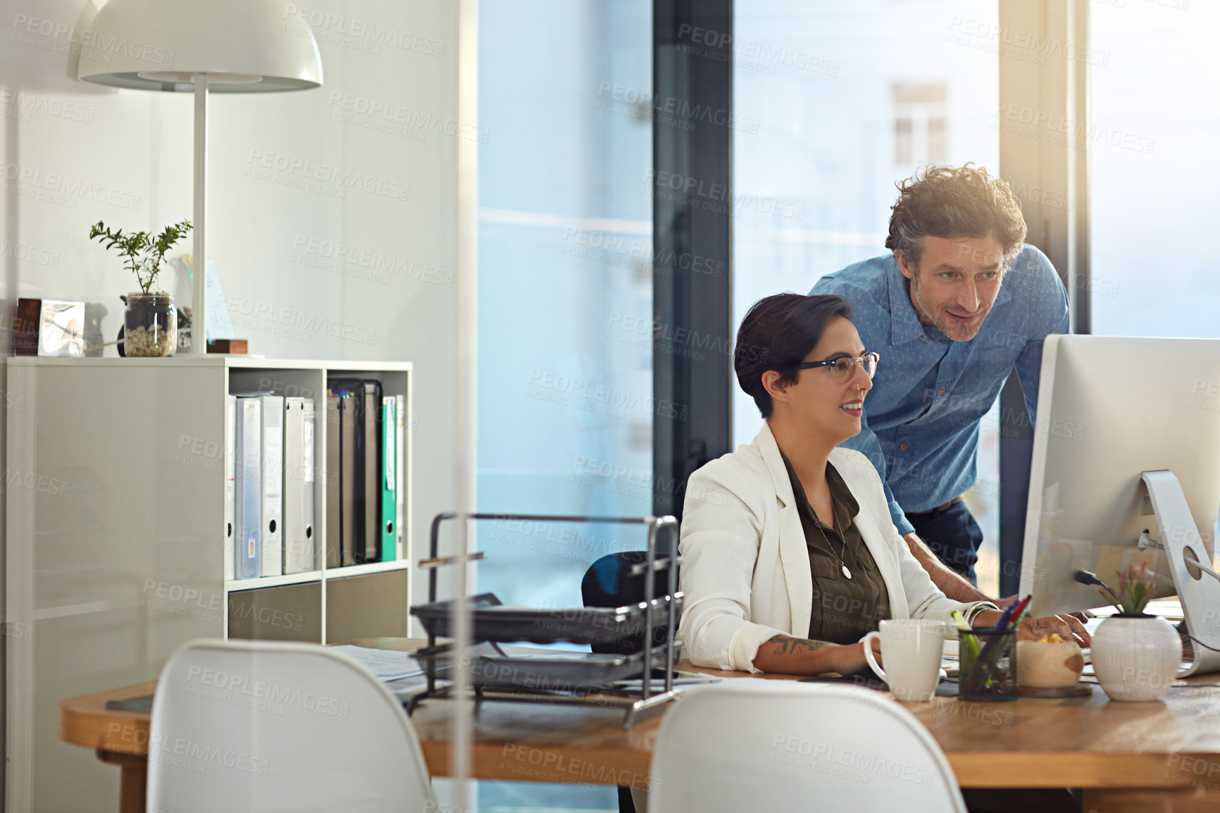 Buy stock photo Shot of businesspeople working on a computer in an office